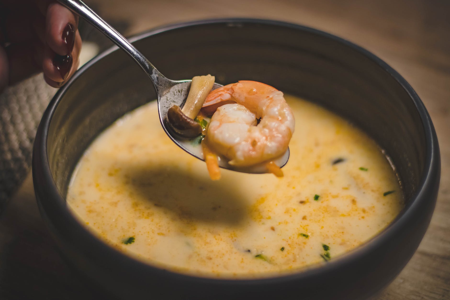 bowl of shrimp soup on brown wooden surface