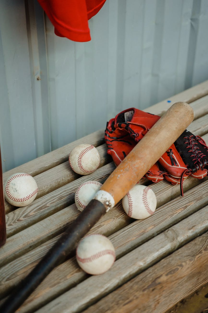 baseball bat and balls on a bench
