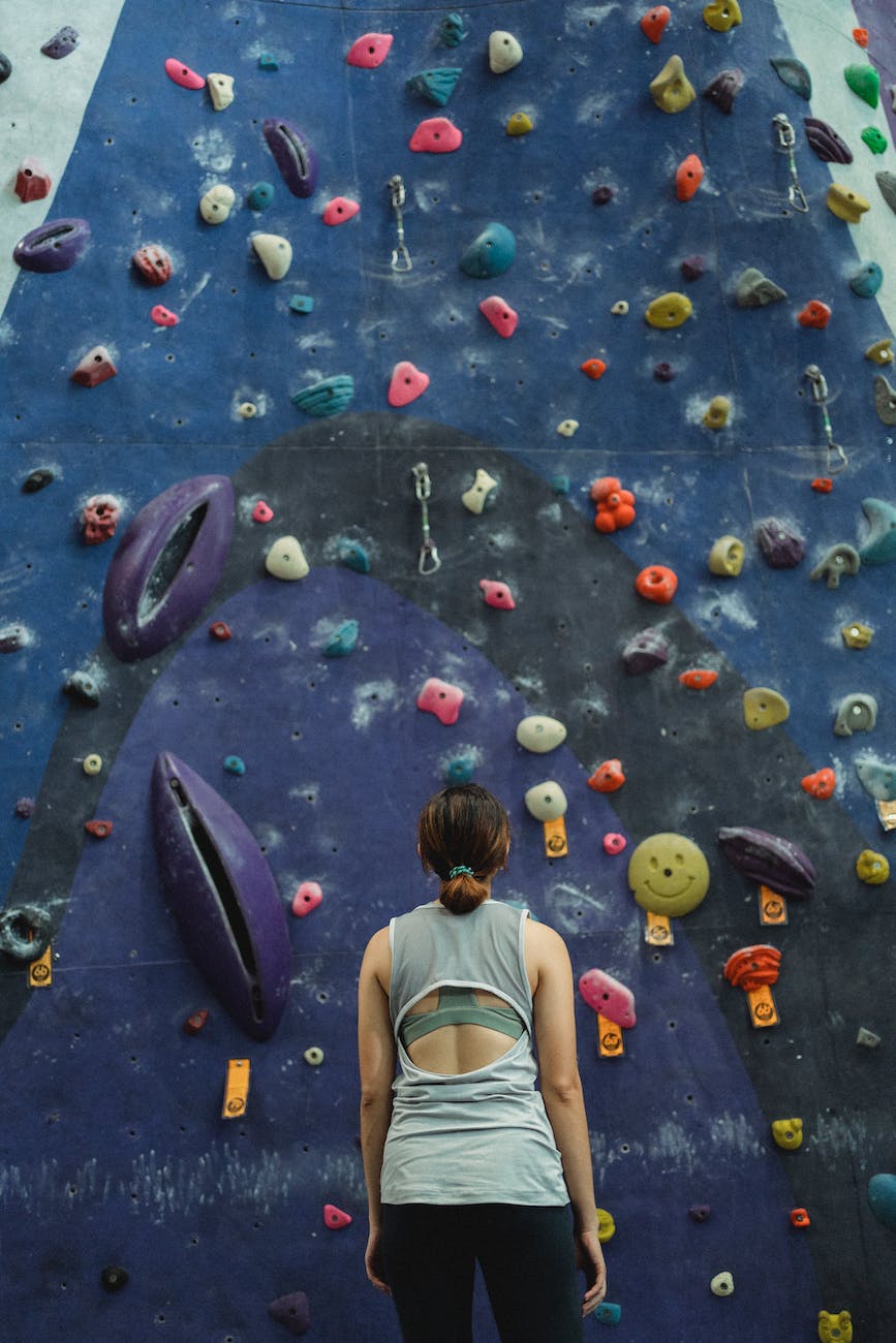 woman preparing for climbing high on wall
