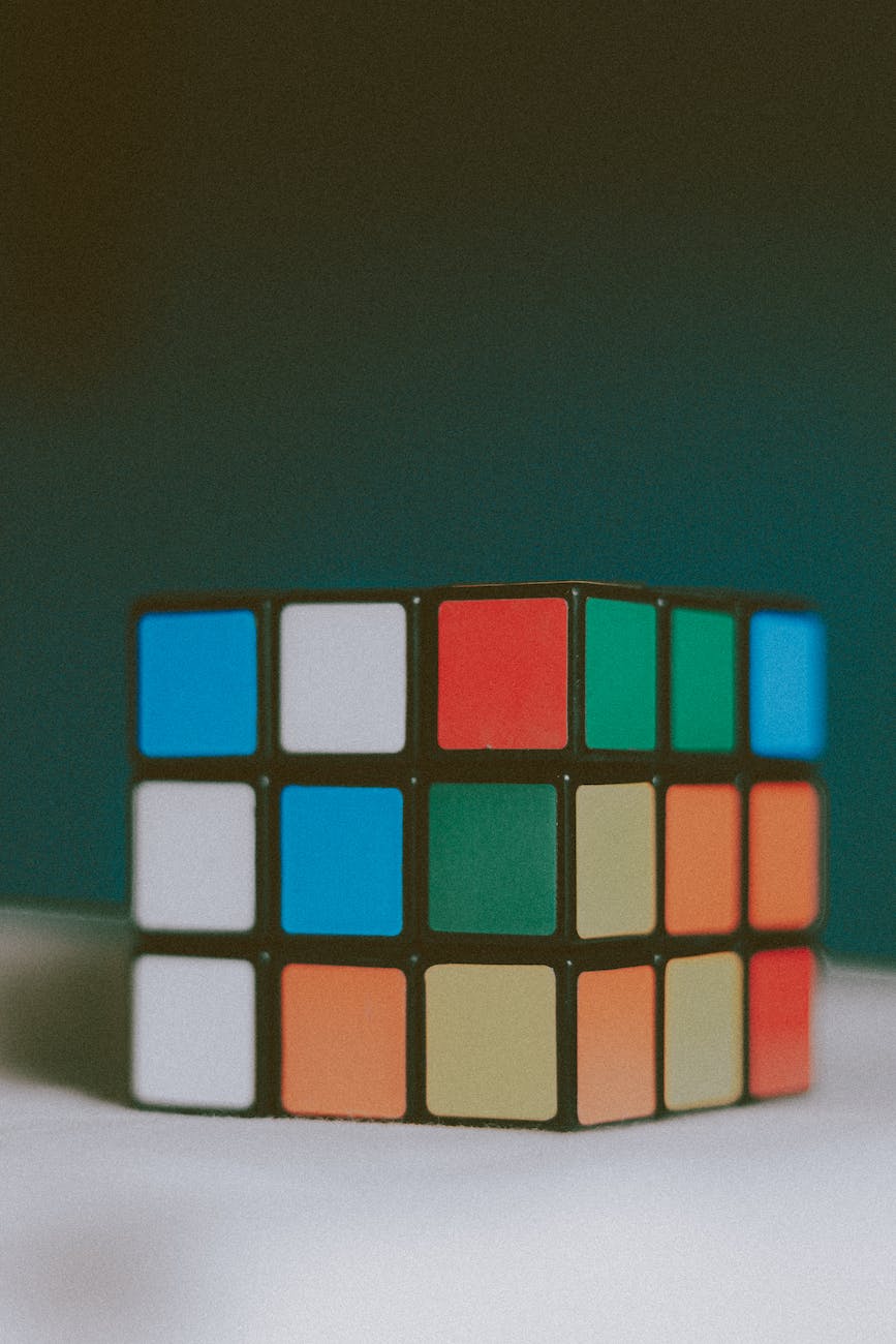colorful puzzle cube placed on white surface