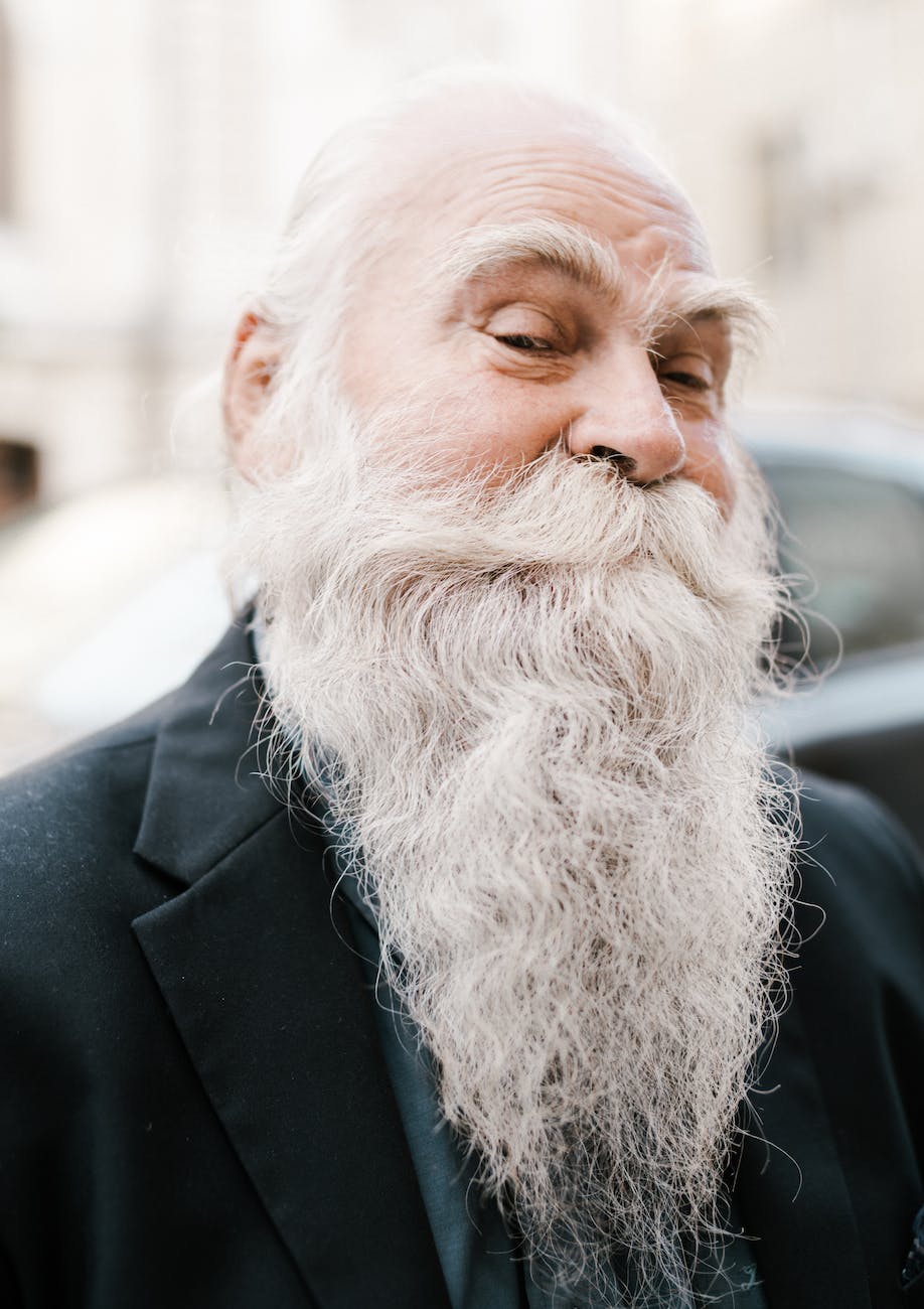 positive elderly bearded male in elegant blazer