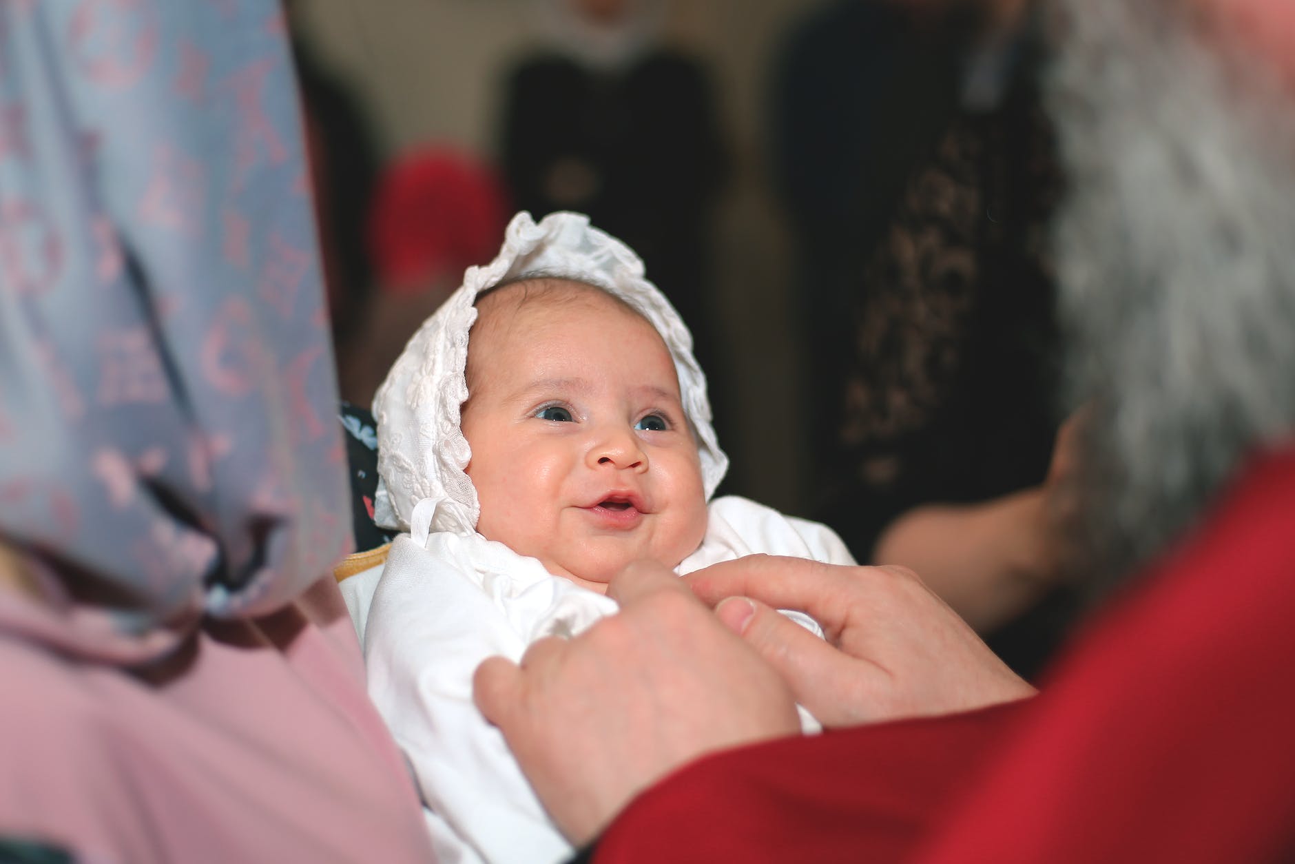 a little baby smiling during baptism